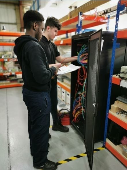 Our newest apprentices working with an AGI cabinet.